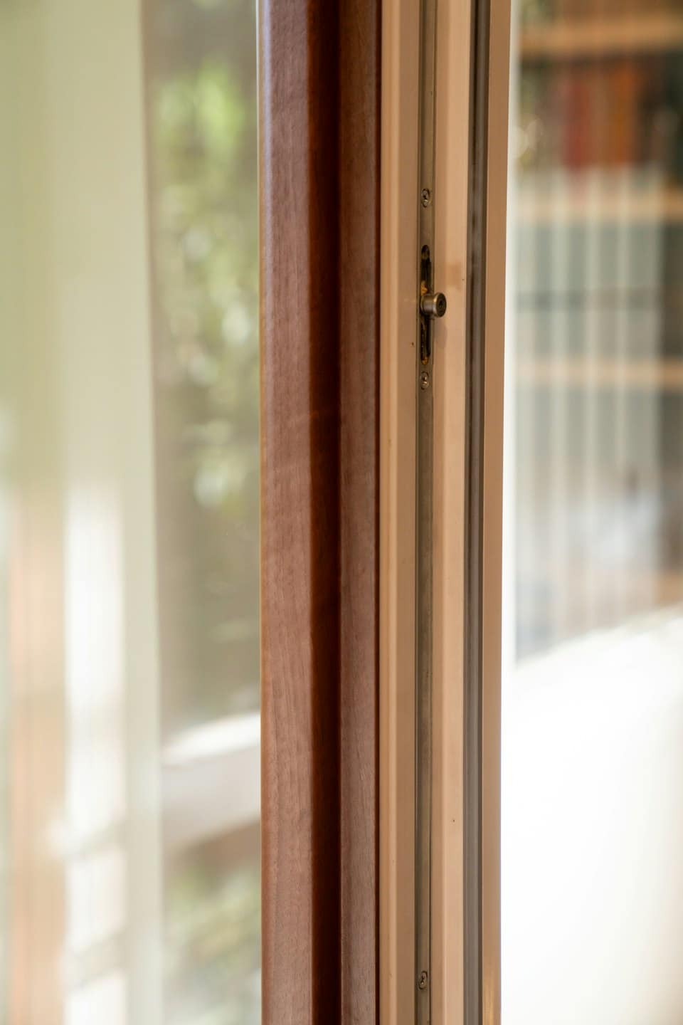 Modern window frame with wood trim and a locking mechanism.